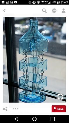 a blue glass bottle hanging from a window