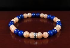 AAA Quality Natural 6mm Lapis Lazuli gemstones, AAA Quality Natural 6mm Orange Sunstone gemstones, with a .925 Sterling Silver bead. It's most connected with the Sacral and Solar Plexus Chakras. A great gift for Leo, Libra, Virgo, and Taurus Zodiac signs. (Style # LM105) ◭ LAPIS LAZULI is known to be a stone of truth, intuition, and wisdom. It's a stone that allows for deeper connection to inner-self and the ability to claim personal power. It's connected to the Solar plexus and third eye Chakras, creating balance and divine will.  ◭ ORANGE SUNSTONE is known for awakening the consciousness. It's said to hold the power of light and has been used to increase positive thinking and gives the power to confront any of life's difficult situations. It has also been used to release or elevate stres Psychic Protection, Protection Bracelet, Personal Power, Solar Plexus, Natural Energy, Healing Bracelets, Silver Accents, Sterling Silver Bead, Gemstone Bracelet