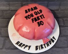 a pink birthday cake with the words, adam you old fart 30 happy birthday