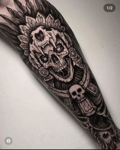 a black and white tattoo with skulls on it