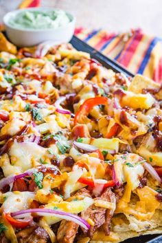 a tray filled with nachos covered in cheese and toppings