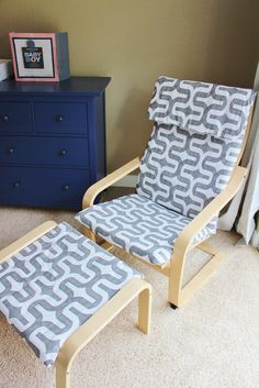 a chair and foot stool in a room with carpeted floor, dresser and blue drawers