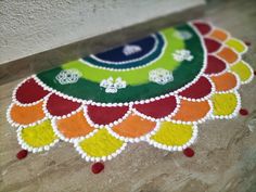 Different colors rangoli with patches and dots. Easy Half Rangoli Designs, Easy Circle Rangoli Designs, Half Rangoli Designs Diwali, Small Beautiful Rangoli, Kalichodas Rangoli, Rangoli Round Designs, Half Circle Rangoli Designs Diwali, Half Rangoli Designs Easy, Rangoli Designs Circle