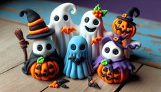 a group of halloween figurines sitting on top of a wooden table