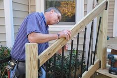 a man standing on top of a wooden stair case