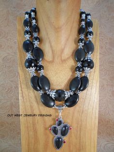 Take a look at this fabulous, chunky, double strand, Western Cowgirl necklace!! I put it together using graduated sizes of black howlite ovals, graduated sizes of shiny black agate rounds and some extra large, faceted black agate rounds.  Lots of premium Tibetan silver spacer beads and bead caps.  The focal point of this gorgeous piece is the 1-1/4" x 2" Black Howlite Prickly Pear cactus pendant that is set in a Tibetan silver setting decorated with small red crystals representing cactus flowers Rodeo Jewelry, Cowgirl Necklaces, Pear Cactus, Prickly Pear Cactus, Cactus Flowers, Chunky Jewelry, Western Cowgirls, Cow Girl, Western Cowgirl