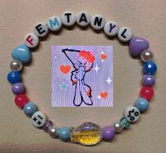 a child's beaded bracelet with an image of a cartoon character on it