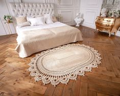 a large bed sitting on top of a wooden floor