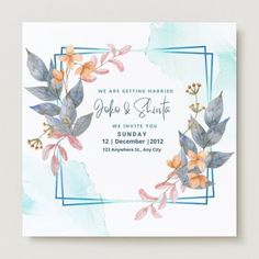 a wedding card with watercolor flowers and leaves on the front, in blue frame