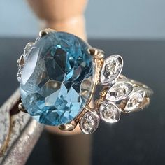 This gorgeous cocktail ring is patiently waiting to adorn your finger!  Ocean blue topaz is 1cm long by 0.8cm wide, bookended by 10 natural diamonds set in white gold.  Hallmarked 10K  Ring weighs 3.2g Size 6.75 Luxury Fine Jewelry Topaz Ring Collectible, Luxury Antique Topaz Ring For Formal Events, Exquisite Luxury Hallmarked Topaz Ring, Vintage Luxury Topaz Ring Collectible, Luxury Collectible Topaz Ring, Luxury Heirloom Yellow Gold Topaz Ring, Luxury Multi-stone Classic Topaz Ring, Luxury Multi-stone Topaz Ring, Patiently Waiting