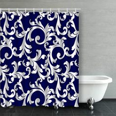 a blue and white shower curtain with an ornate design on it's side, next to a bathtub