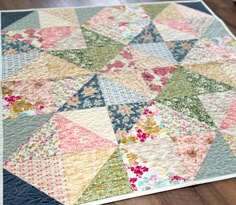 a close up of a quilt on the floor