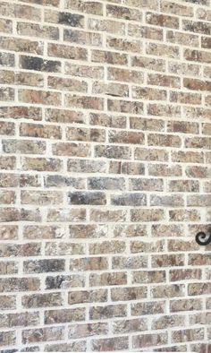 a clock on the side of a brick building