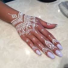 a woman's hand painted with white hennap on top of a counter