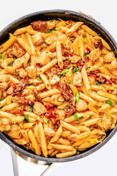 pasta with meat and sauce in a pan on a white table top, ready to be eaten