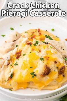 a white plate topped with chicken and cheese covered casserole on top of a table