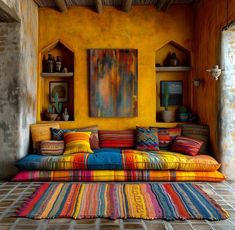 a brightly colored couch sitting in front of a yellow wall