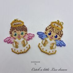 two beaded angel charms on a white background