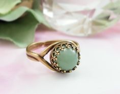 "This green gemstone ring is made with an 8mm round, smooth genuine green aventurine gemstone cabochon and is set in a lovely antiqued bronze Victorian crown bezel ring. This adjustable ring will fit just about any finger and makes a great green gemstone jewelry gift for her. Thank you for looking. - Shop Gemsicles, an Etsy boutique with hundreds of sparkly items for weddings, gifts and just because. Our original jewelry designs feature gemstones, Swarovski® crystals, pearls, CZs, vintage compon Aventurine Round Jewelry For May Birthstone, Aventurine Jewelry For May Birthstone In Round Shape, Aventurine Jewelry For May Birthstone, Green Jade Round Stone Jewelry, Green Jade Jewelry With Round Stone, Green Jewelry With Round Band For Gift, Adjustable Jade Ring, Green Oval Cabochon Birthstone Jewelry, Green Round Band Jewelry Gift