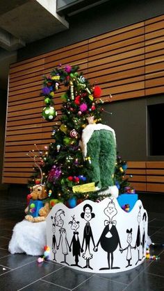 a decorated christmas tree in an office lobby