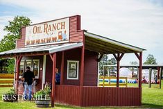 people are standing outside of an old ranch store