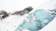 a large iceberg in the middle of a snowy mountain