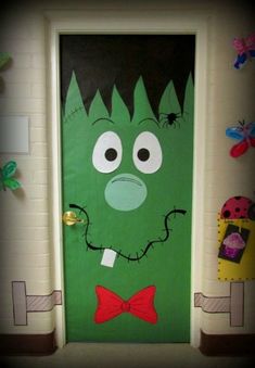 a green door decorated with an image of a monster