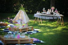 an outdoor party with tables and chairs set up in the grass for a tea party