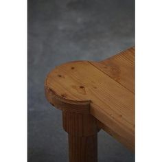 a wooden bench sitting on top of a cement floor