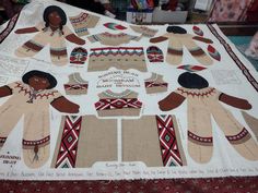 a quilted table cloth with an image of women's sweaters on it