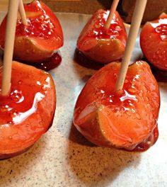 several pieces of fruit with toothpicks sticking out of them on top of a table