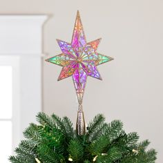 a christmas tree topper with an ornament in the shape of a star