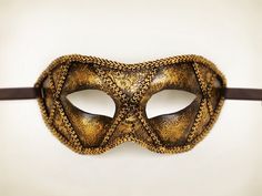 Antiqued metallic gold masquerade mask for men. Special handpainting for antiqued look: two layers of paint, black and gold, patinated with sponge. Decorated with lace and braided trimming. Your order will be delivered with online tracking by UPS or FedEx. Base mask is made of plastic. Ribbons are added both sides to tie. Standard size fits most (for men). This classical Venetian mask is perfect for any costume party, masquerade, carnival, wedding, prom. Since it's totally handmade, the mask you Black And Gold Masquerade Mask, Gold Masquerade Mask, Royal Costume, Mens Masquerade Mask, Dr Wardrobe, Bridal Mask, Mask For Men, Paint Black, Masquerade Masks