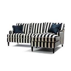 a black and white striped couch with blue pillows