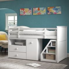 a white bunk bed sitting next to a desk with drawers and a book shelf on top of it