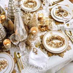 the table is set with gold and white dishes