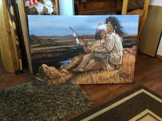 two native american paintings sitting on the floor