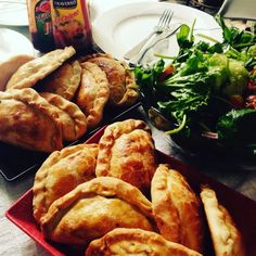 several different types of pies and salad on a table next to a can of soda