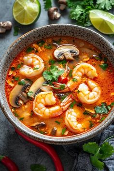 a bowl of shrimp soup with mushrooms and cilantro