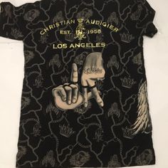 a black t - shirt with the words los angeles written on it and two fingers pointing at each other