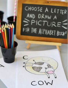 a blackboard with the words choose a letter and draw a picture for the alphabet book