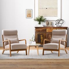 two chairs sitting next to each other on top of a hard wood floored floor