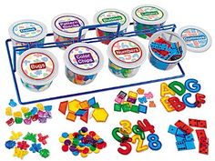 an assortment of plastic letters and numbers on a tray with magnets for learning the alphabet