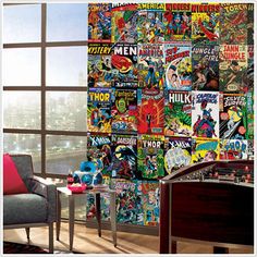 a living room filled with furniture and lots of comic books on the wall behind it