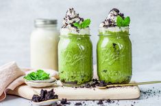 two mason jars filled with green smoothie