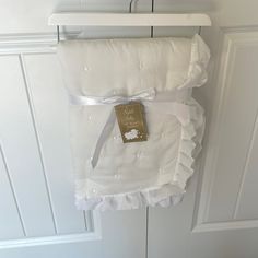 a white dress hanging on a door with a tag attached to the back of it