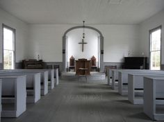 an empty church with pews and chairs