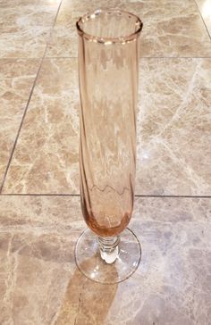 a clear glass sitting on top of a tiled floor