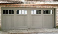 two garage doors are open on the side of a brick building