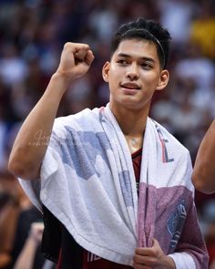 a young man is holding his fist up in the air